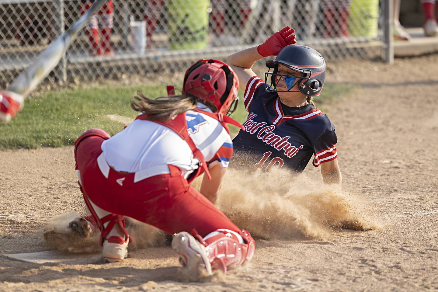 West Central’s Addie Seitz is tagged out at home by Morrison catcher Allie Anderson to keep it a one-run game Wednesday, May 24, 2023 during their Class 1A sectional semifinal at St. Bede Academy.