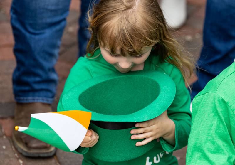 Eleanor Pennington, 4, admires her hat filled with candy during the St. Charles St. Patrick’s Parade on Main Street in St. Charles on Saturday, March 15, 2025.