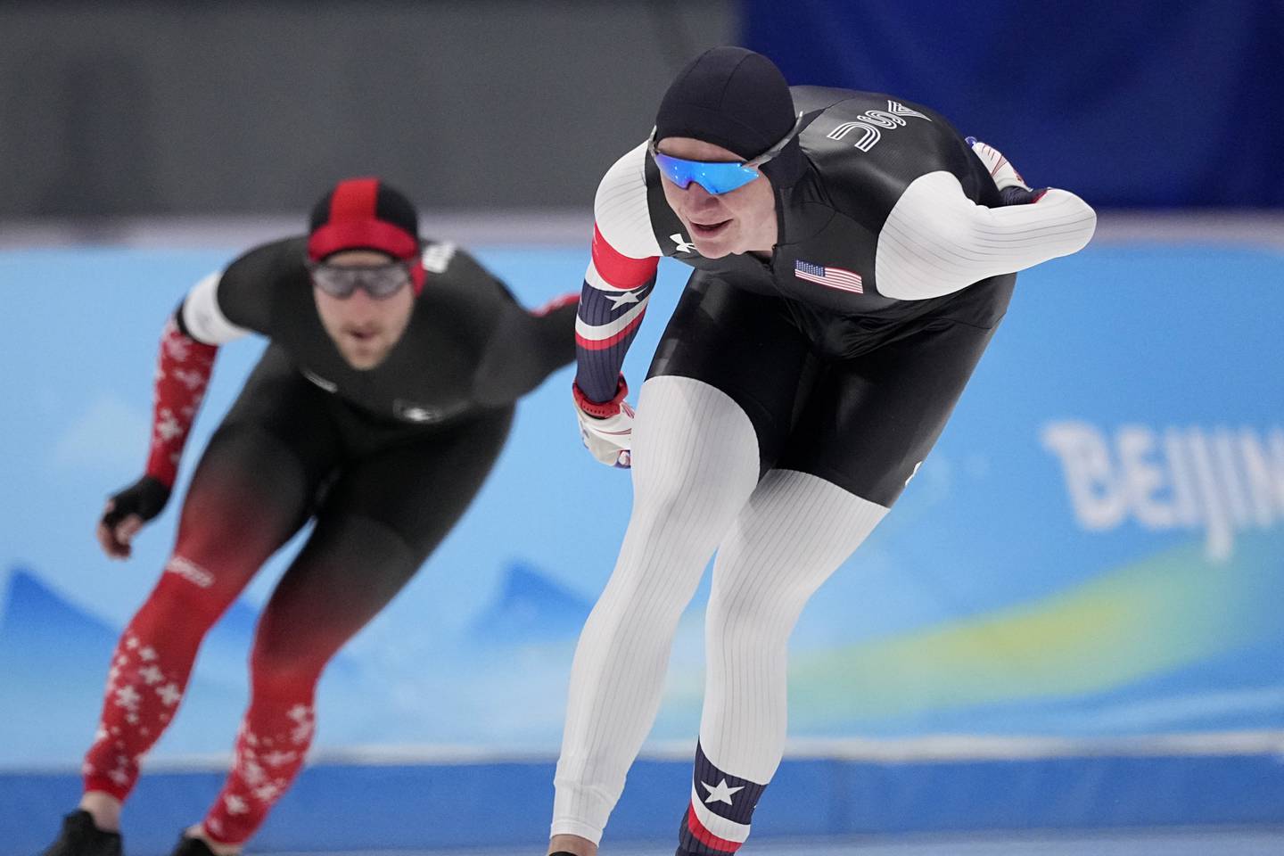 Ethan Cepuran of the United States, right, competes with Livio Wenger of Switzerland during the men's speedskating 5,000-meter race at the 2022 Winter Olympics, Sunday, Feb. 6, 2022, in Beijing. (AP Photo/Sue Ogrocki)