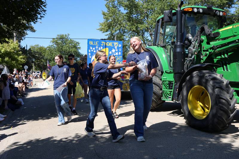 Herscher FFA members Lili Schultz, right, and Evalyn Hoffman help hand out candy during the 104th annual Herscher Labor Day Celebration Grand Parade on Monday, Sept. 1, 2025.
