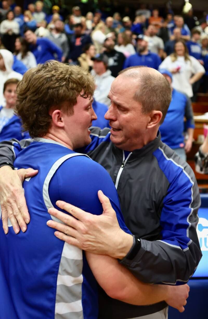 Princeton senior Luke Smith savors a special moment with his dad, Tiger assistant Tim Smith following Friday's regional championship victory over Seneca.