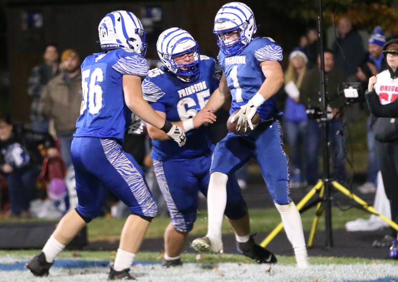 Princeton players Owen Hartman, Cade Odell and Casey Etheridge celebrate after scoring the teams first touchdown against Oregon during the Class 3A playoff game on Friday, Nov. 1, 2024 at Princeton High School.