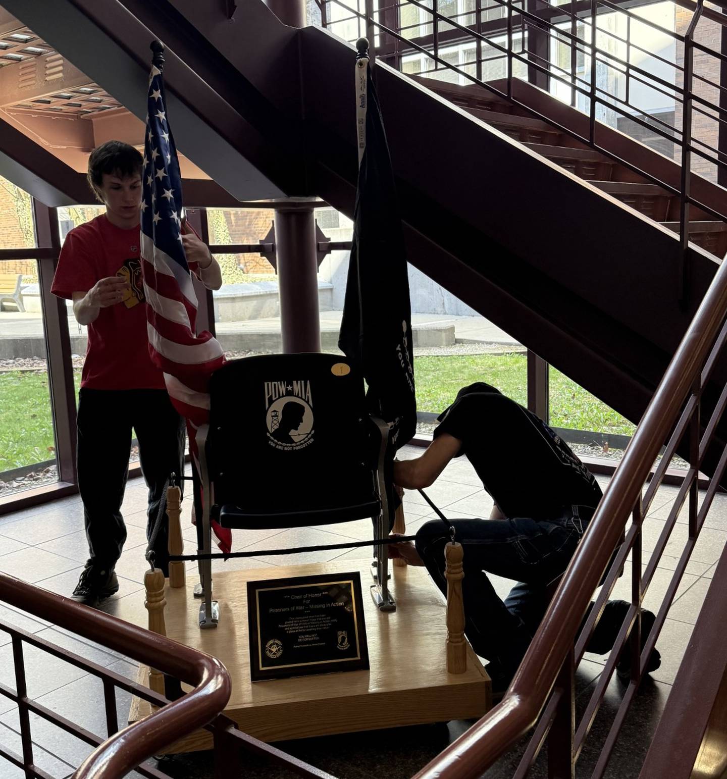 Members of the Rolling Thunder group install a donated Chair of Honor to at the McHenry County courthouse to honor POW and MIA military service members.