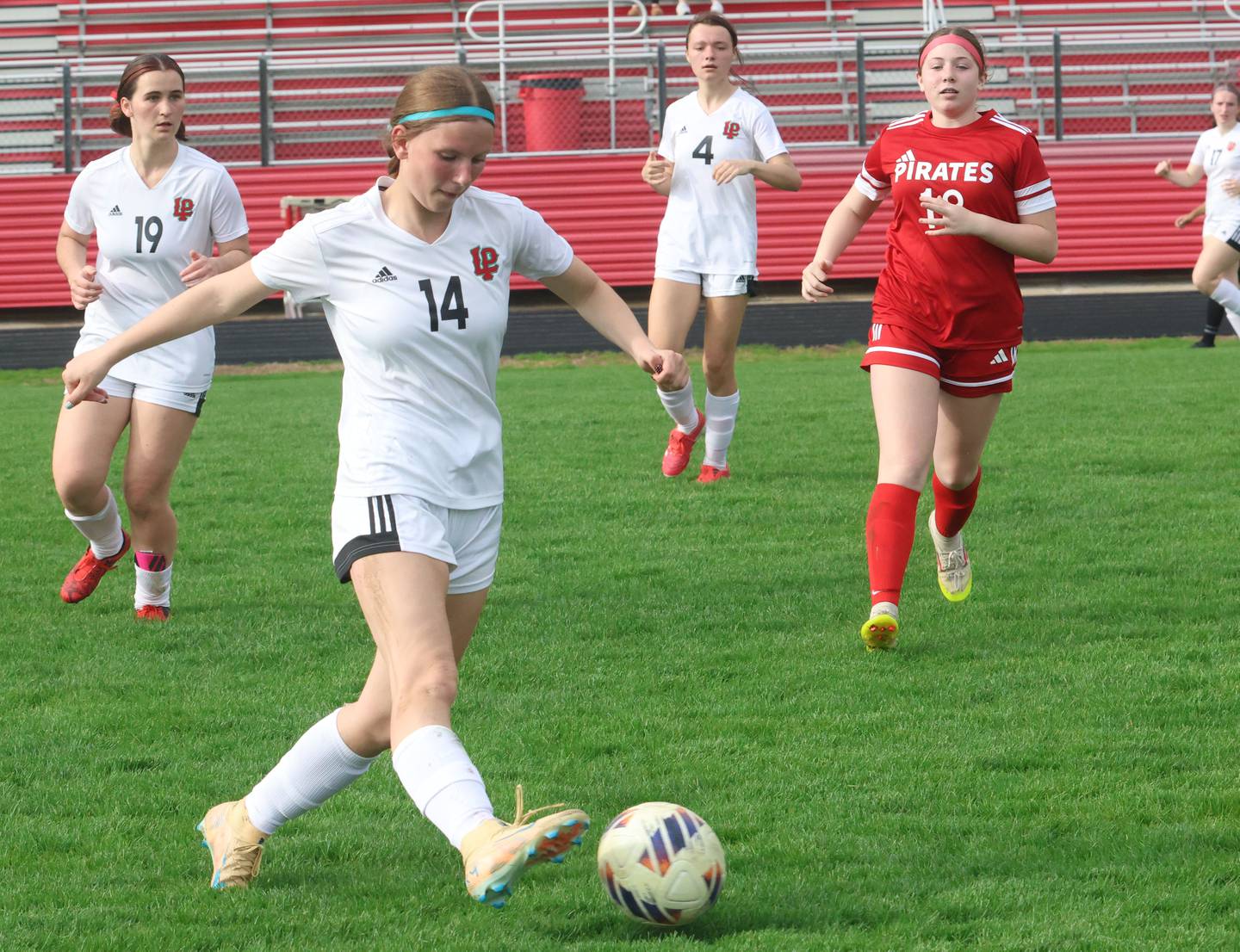 L-P's Rosalie Leininger kicks the ball away from Ottawa's Elle McGrath on Monday, April 13, 2026 on King Field at Ottawa High School.