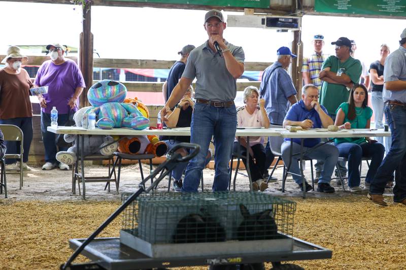 Auctioneer Rob Warmbir runs up the bidding for prize-winning rabbits during the Livestock Auction at the Kankakee County Fair on Saturday, Aug. 2, 2025.