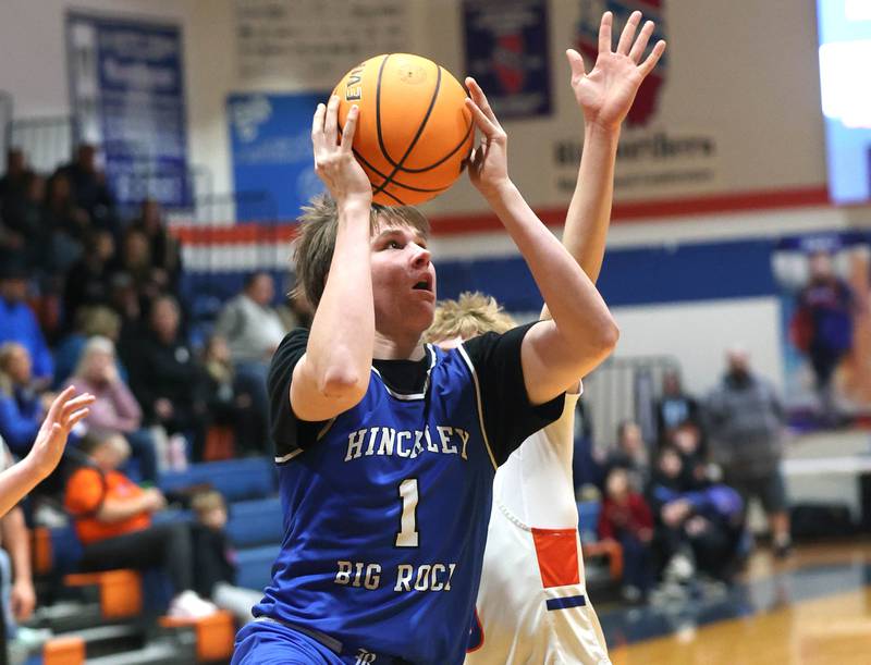 Hinckley-Big Rock's Judah Miceli gets to the basket ahead of a Genoa-Kingston defender Tuesday, Jan. 6, 2026, during their game at Genoa-Kingston High School.