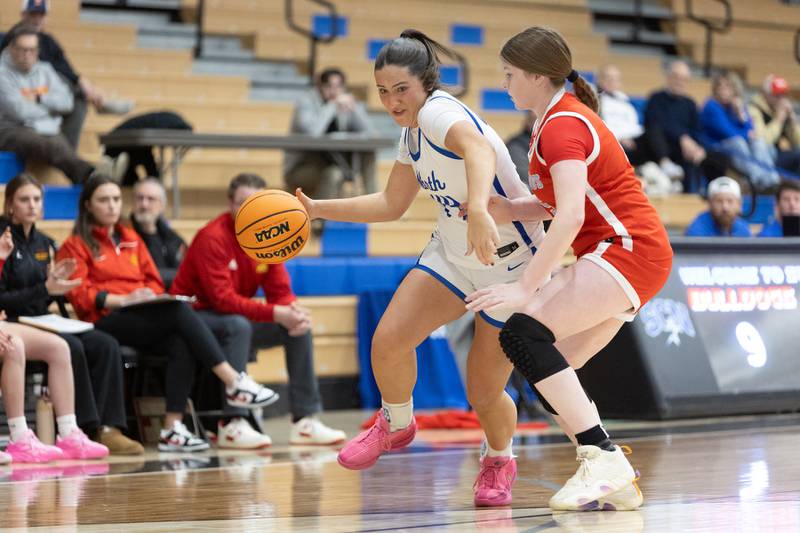 St. Charles North's Riley Barber advances the ball up court against Batavia's Sammie Donahue on Friday, Dec.12,2025 in st. Charles.