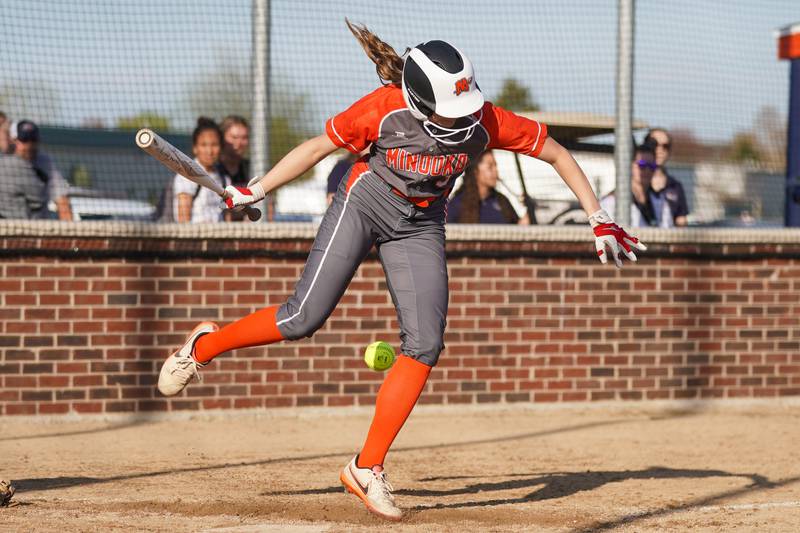 Minooka's Mayson Carr (3) is hit by a pitch during a Southwest Prairie Conference softball game against Oswego at Oswego High School on Wednesday, April 23, 2025.