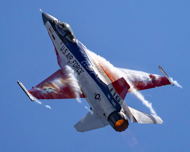 The air around the F-16 piloted by Major Taylor "Fema" Hiester super cools forming condensation clouds on the outside of his aircraft during the 10th annual TBM Avenger Reunion and Airshow on Saturday, May 17, 2025 at the Illinois Valley Regional Airport in Peru.