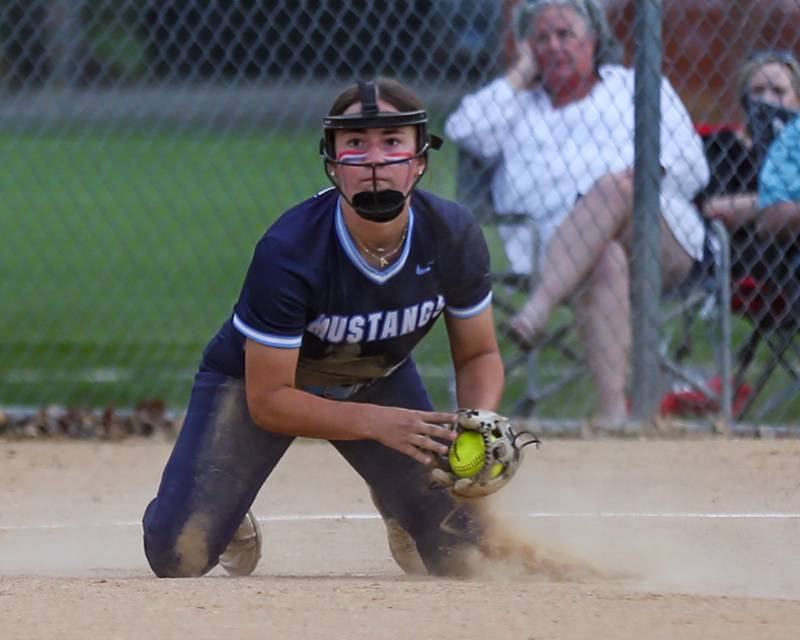 Downers Grove South's Addison Yurchak (11) comes up with a grounder during varsity softball game between Downers Grove South at Downers Grove North.  May 11, 2023.