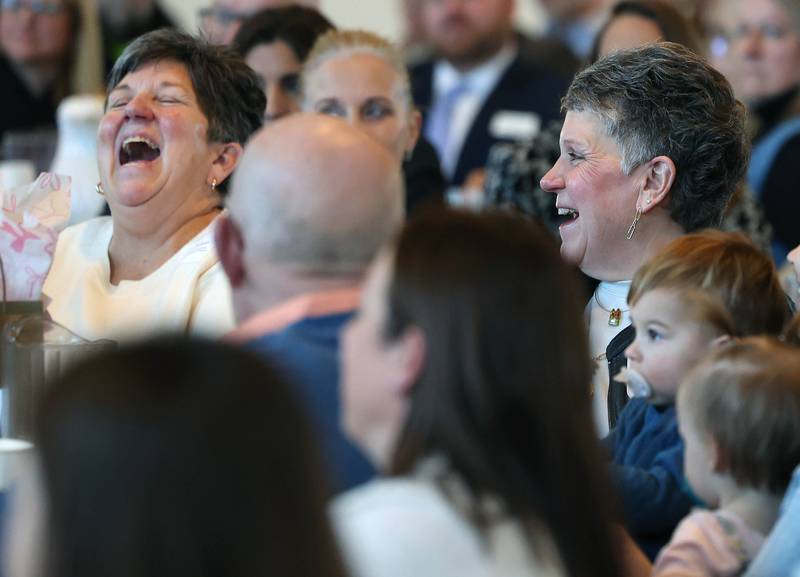 Kris Wrenn (left) and her sister Michelle Schulz, who owned and operated Kar-Fre Flowers, have a laugh as they are introduced as the winners of the Clifford Danielson Outstanding Citizen Award during the Sycamore Chamber of Commerce Annual Meeting Thursday, March 6, 2025, at St. Mary's Catholic Church in Sycamore.