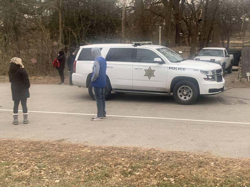 A police vehicle leaves the area where a woman's body was found in the Fox River on Monday, Dec. 5, 2022.