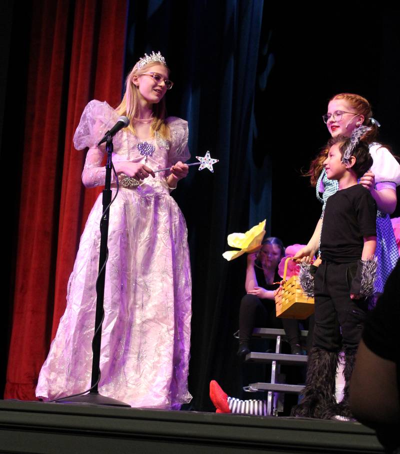 Glinda the Good Witch (Piper Brandenburg) instructs Dorothy Gale (Karsyn Stewart) and Toto (Leo Gonzalez) on Friday, March 22, 2024, during the Streator Elementary Schools production of "The Wizard of Oz – Youth Edition" at Streator High School.