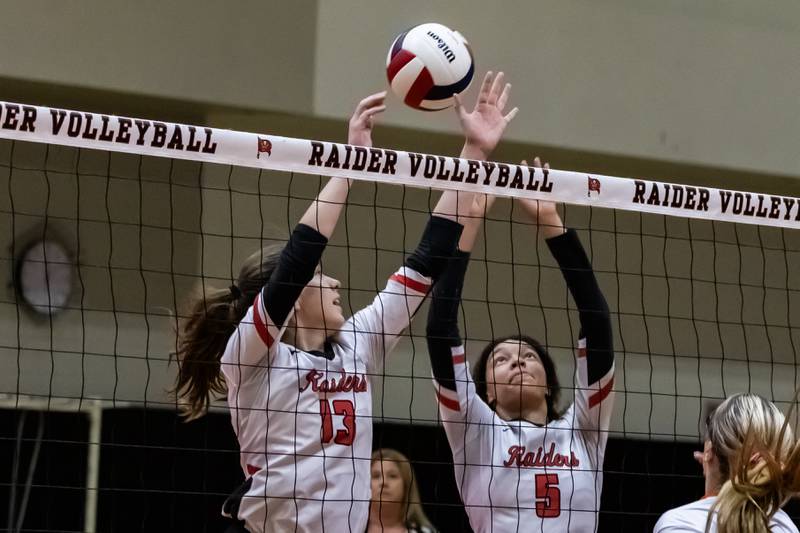 Bolingbrook's Faith Fisher and Bolingbrook's Angelia Robinson attempt a block during a varsity volleyball home game against Minooka on Sept. 25, 2025.
