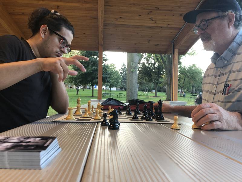 Ozzy Flores, left, considers his next move in a game of chess against Vincent Hart on Tuesday, Sept. 20, 2022, at McHenry's Veterans Memorial Park.