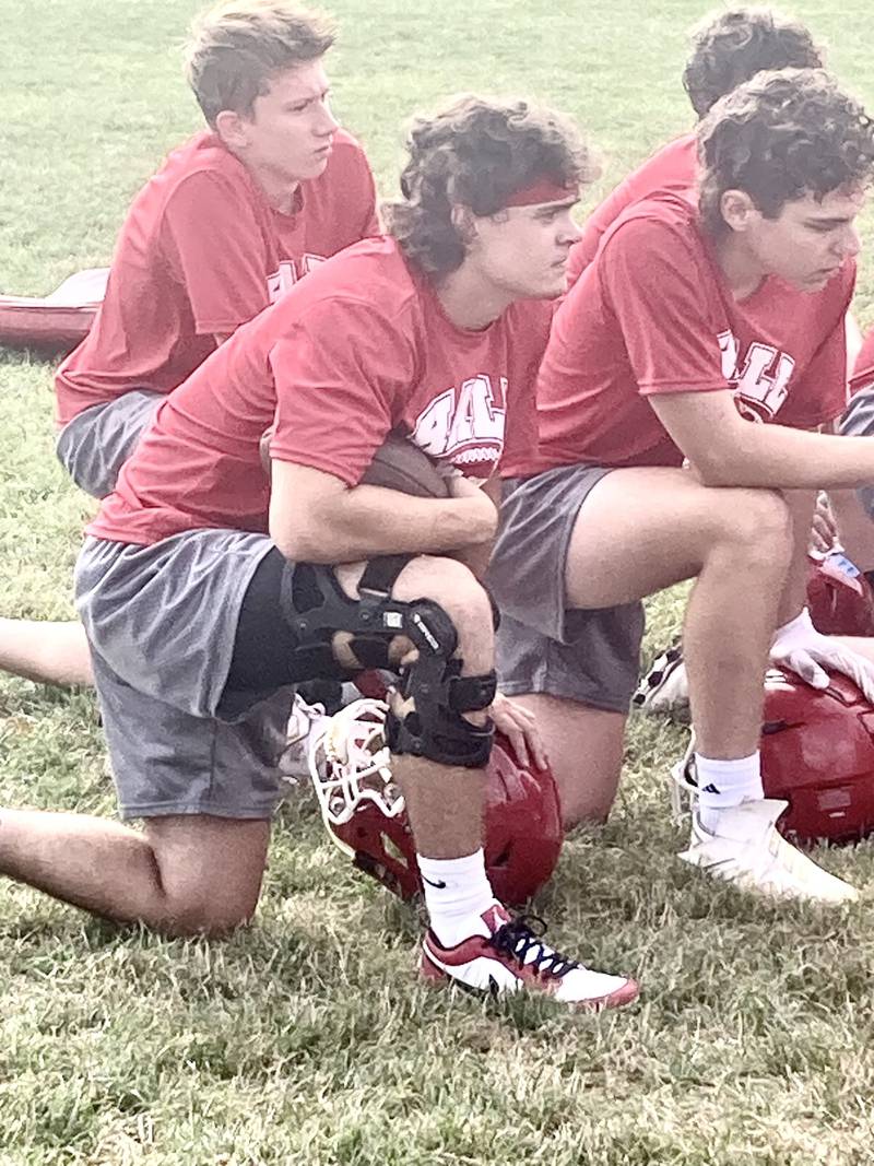 Hall senior Gianni Guerrini sits in on the end of the Red Devils first practice Monday morning. They will open the season Friday, Aug. 25 at Orion.