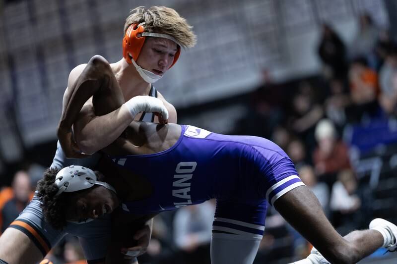 Sandwich's Cooper Corder works to get the upper hand on Plano's Trevion Gilford during their match on Thursday, Jan. 30.