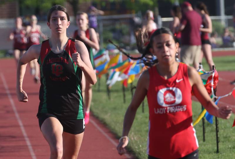 L-P's Ashlee Lord and Ottawa's Shaylen Quinn run in the 800 meter race during the Interstate 8 track conference meet on Friday, May 3, 2024 at the L-P Athletic Complex in La Salle.