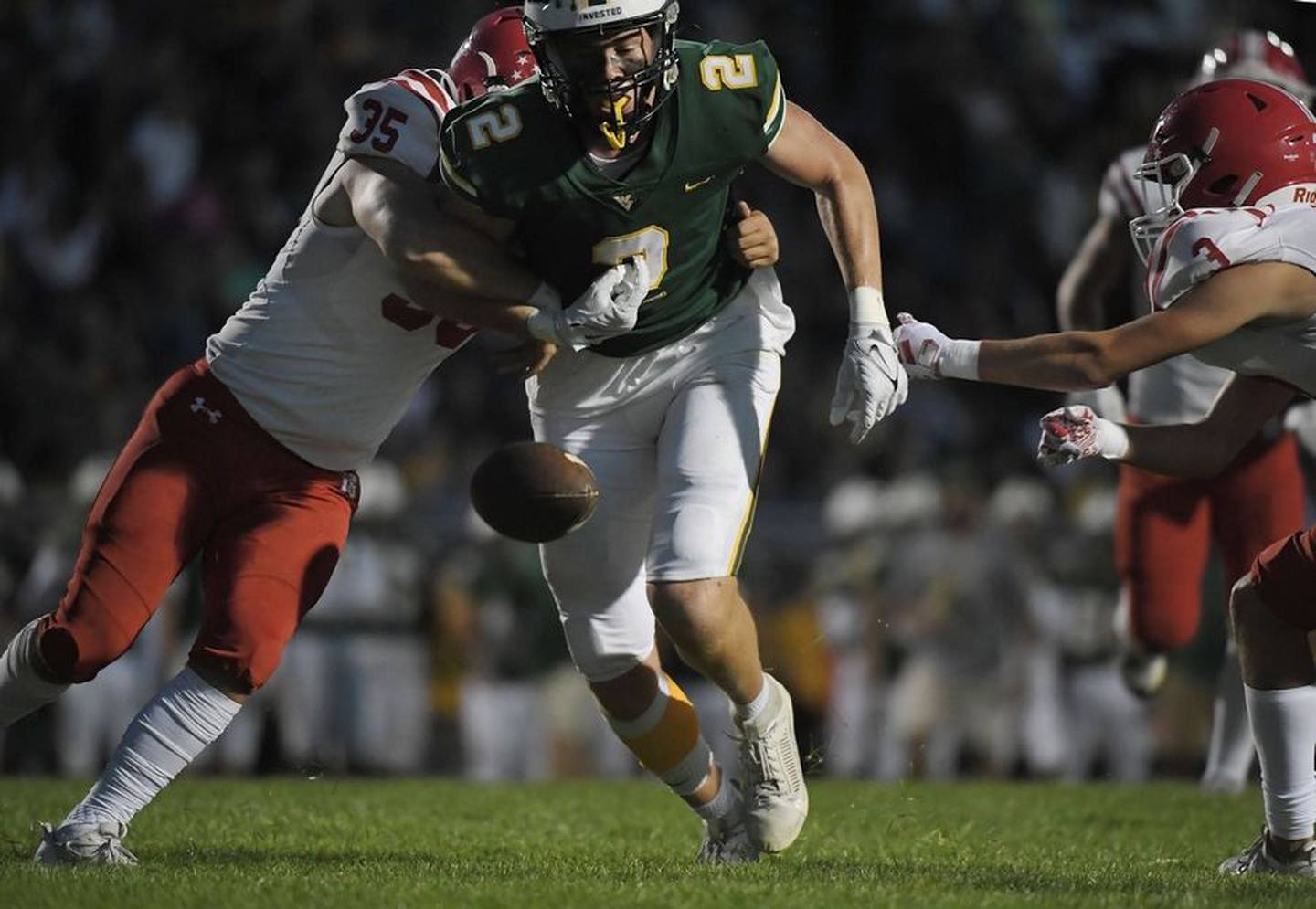 Naperville Central's Sam Figg forces Waubonsie Valley's Julian Johnson to fumble near the goal line in a football game in Aurora on Friday, September 15, 2023. Naperville's Christian Kuta recovered the fumble.