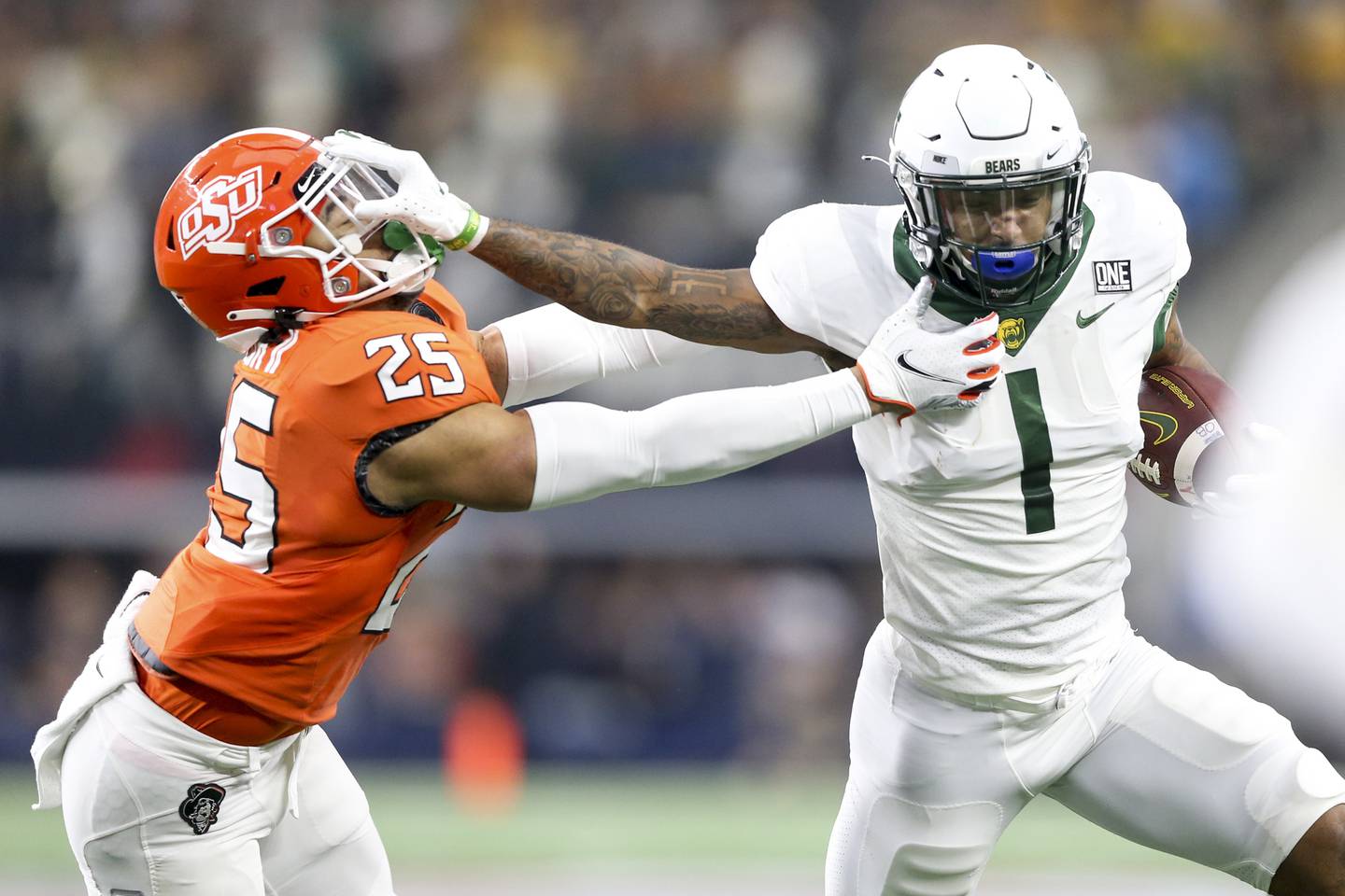 Baylor running back Trestan Ebner stiff arms Oklahoma State safety Jason Taylor II during the Big 12 Conference championship on Dec. 4, 2021 in Arlington, Texas.