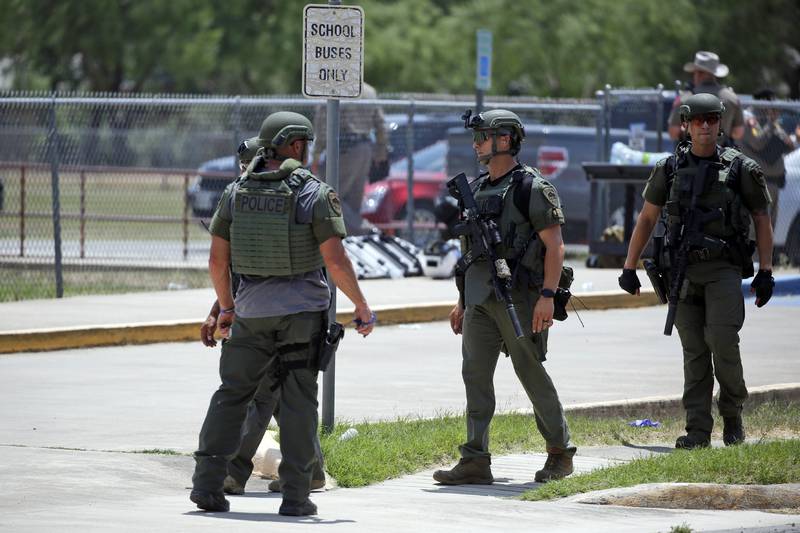 FILE - Law enforcement personnel stand outside Robb Elementary School following a shooting, May 24, 2022, in Uvalde, Texas. (AP Photo/Dario Lopez-Mills, File)