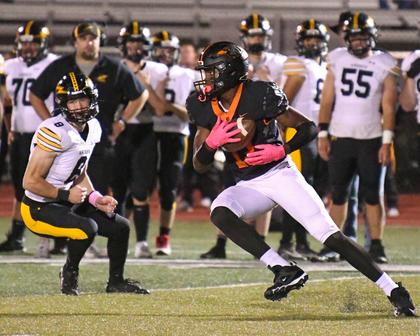 DeKalb's Davon Grant, right, gains a few extra yards after catching the ball while being defended by Andrew High School Scott Oftedahl, left, during the game on Friday Oct. 4, 2024, held at DeKalb High School.