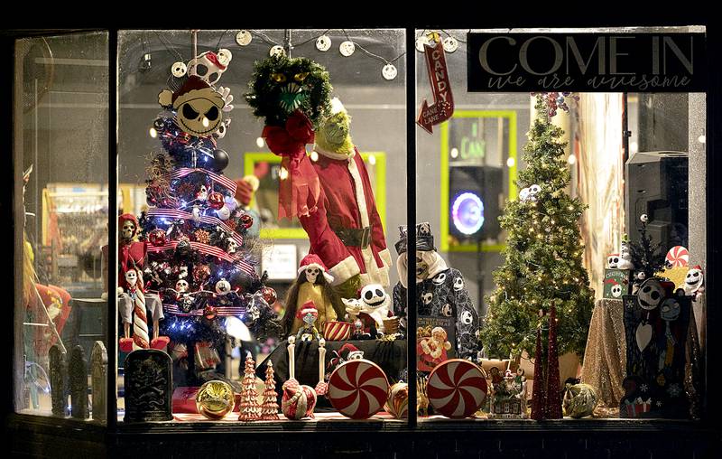 The Grinch lurks in the window of a downtown business Friday, Dec. 6, 2024, in Dixon.