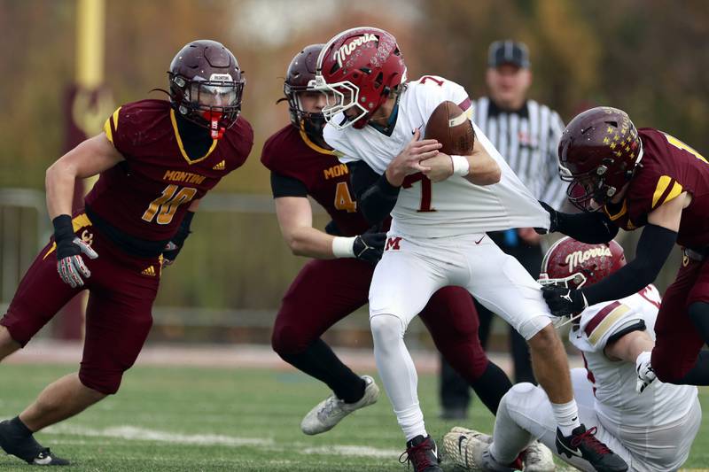 Morris' Brady Varner (7) moves out of the pocket and is surrounded by a host of Montini players during the IHSA Class 4A semifinals football playoff game Saturday, Nov. 22, 2025 in Lombard.
