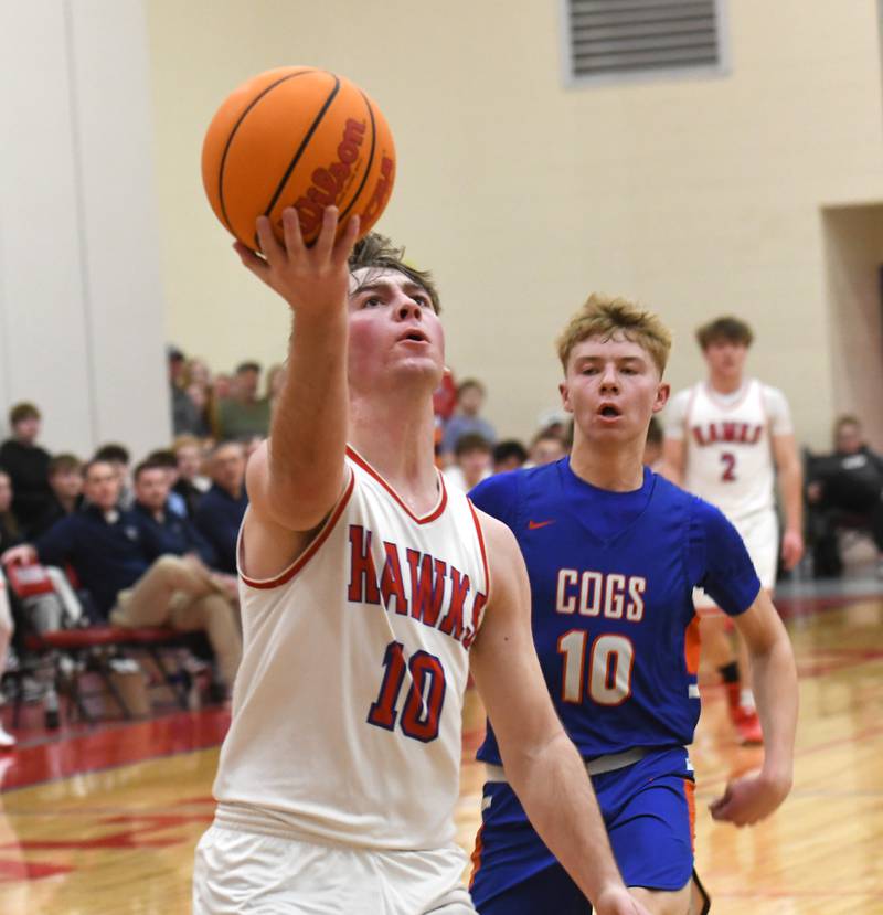 Oregon's Keaton Salsbury drives in for a lay up while Genoa-Kingston's Trevor Rhoads follows on Friday, Jan. 30, 2026 at the Blackhawk Center in Oregon.