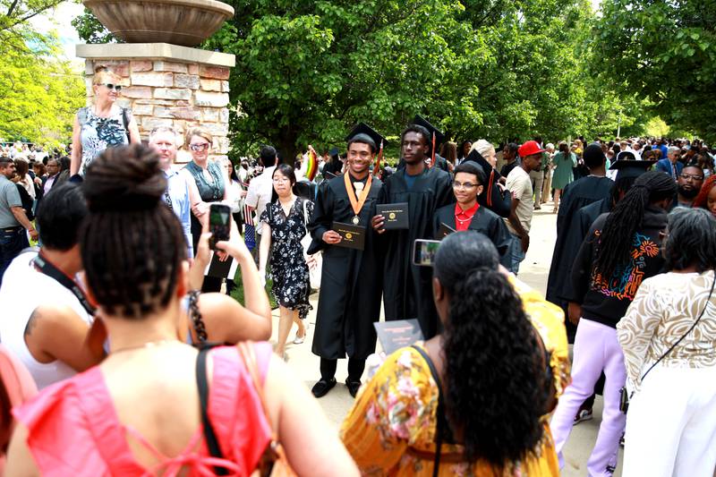 Wheaton Warrenville South graduates pose for photos following the school’s commencement ceremony on Saturday, May 24, 2025 at the College of DuPage in Glen Ellyn.