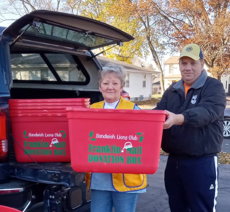 Sandwich Lions Christine Bailey and Kyle Wallis load grocery collection bins for distribution to local businesses. Wallis is the grandson of project founder, Franklin Mall.