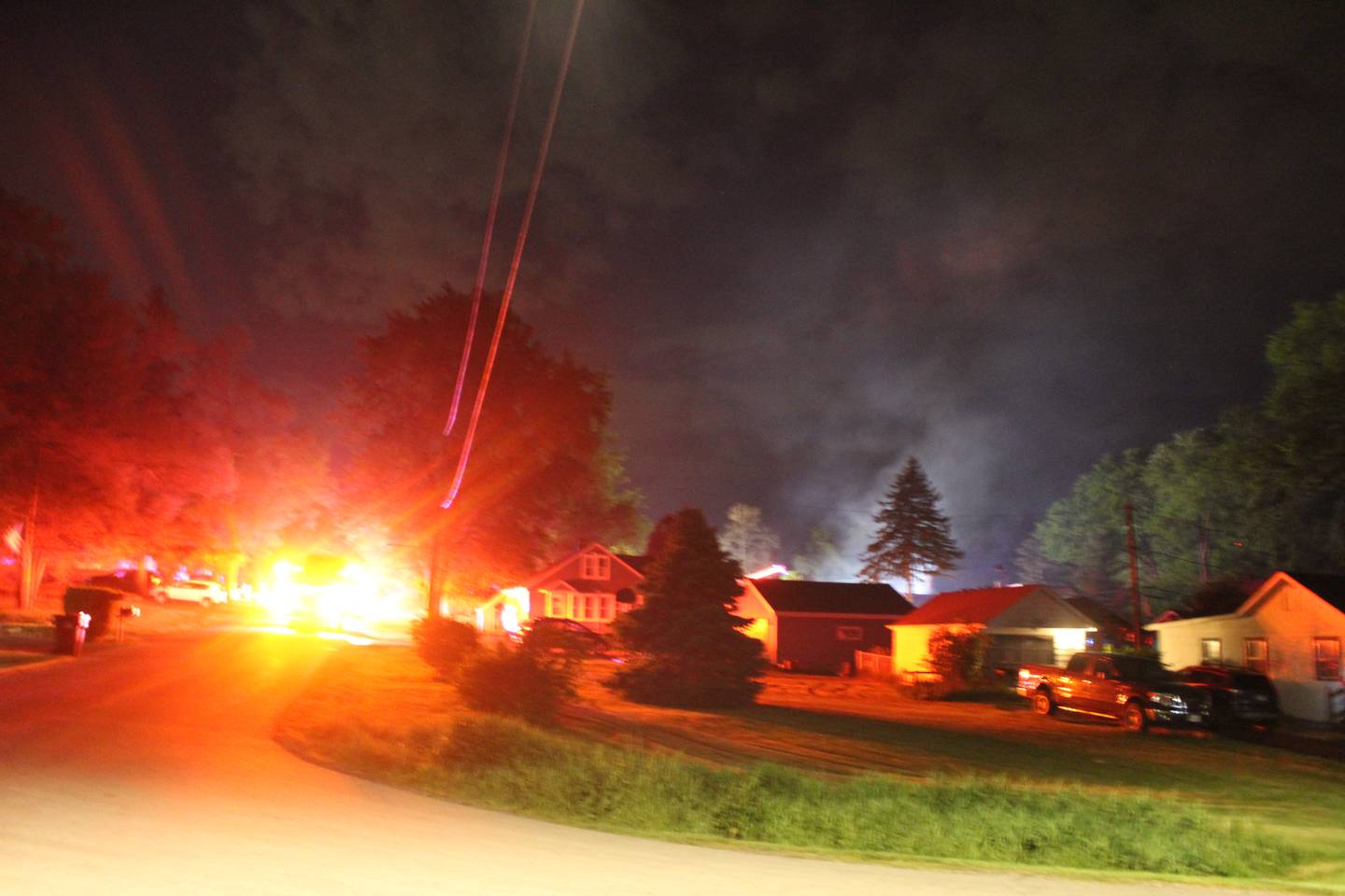 Smoke is visible in the night sky as fire crews and the McHenry County Sheriff's Office respond to a house explosion on May 17, 2026, in Wonder Lake.