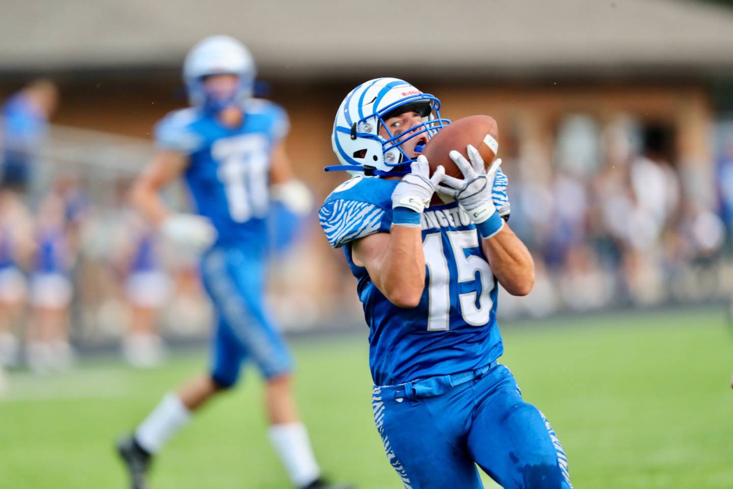 Princeton senior Augie Christiansen hauls in a catch against Orion Thursday night at Bryant Field. The Tigers won 60-20.