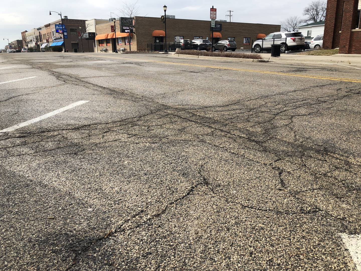 The city of Harvard will ask residents to approve a local sales tax hike on the April 4 referendum. This photo, taken on Wednesday, Jan. 11, 2023, of Ayer Street in downtown, shows the cracking prevalent on many Harvard streets.