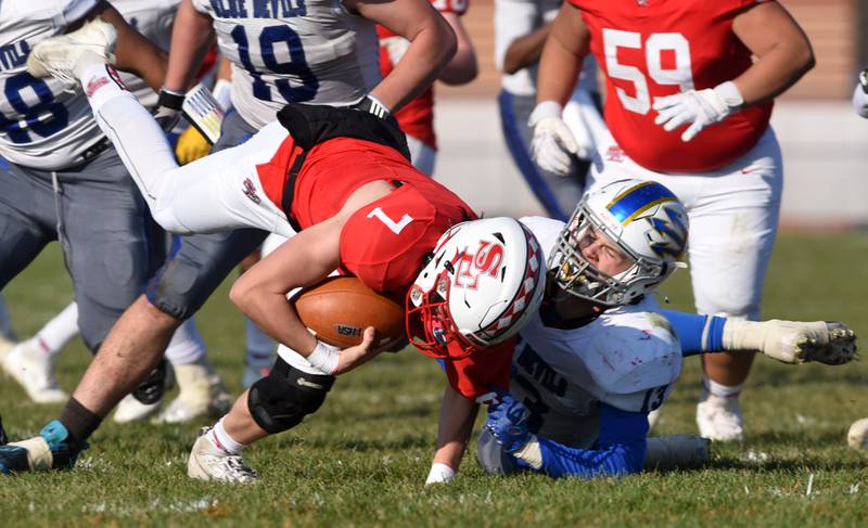 Joe Lewnard/jlewnard@dailyherald.com
South Elgin quarterback John Ginnan gets sacked by Warren’s Liam Wiley during the Class 8A second-round football game at South Elgin Saturday.