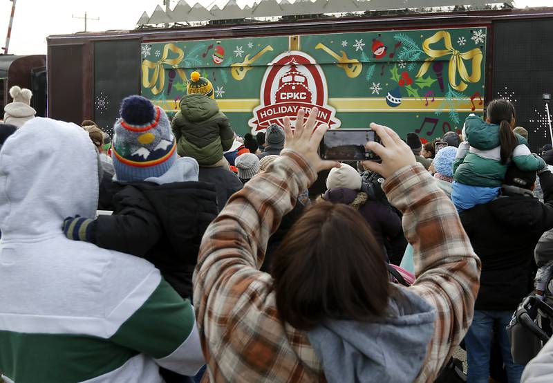 People photograph the Canadian Pacific Kansas City Railway 2024 Holiday Train on Wednesday Nov. 27, 2024,  as the train pulls into Pingree Grove. The holiday train raised food and monetary donations for the D300 Food Pantry during its stop in Pingree Grove.