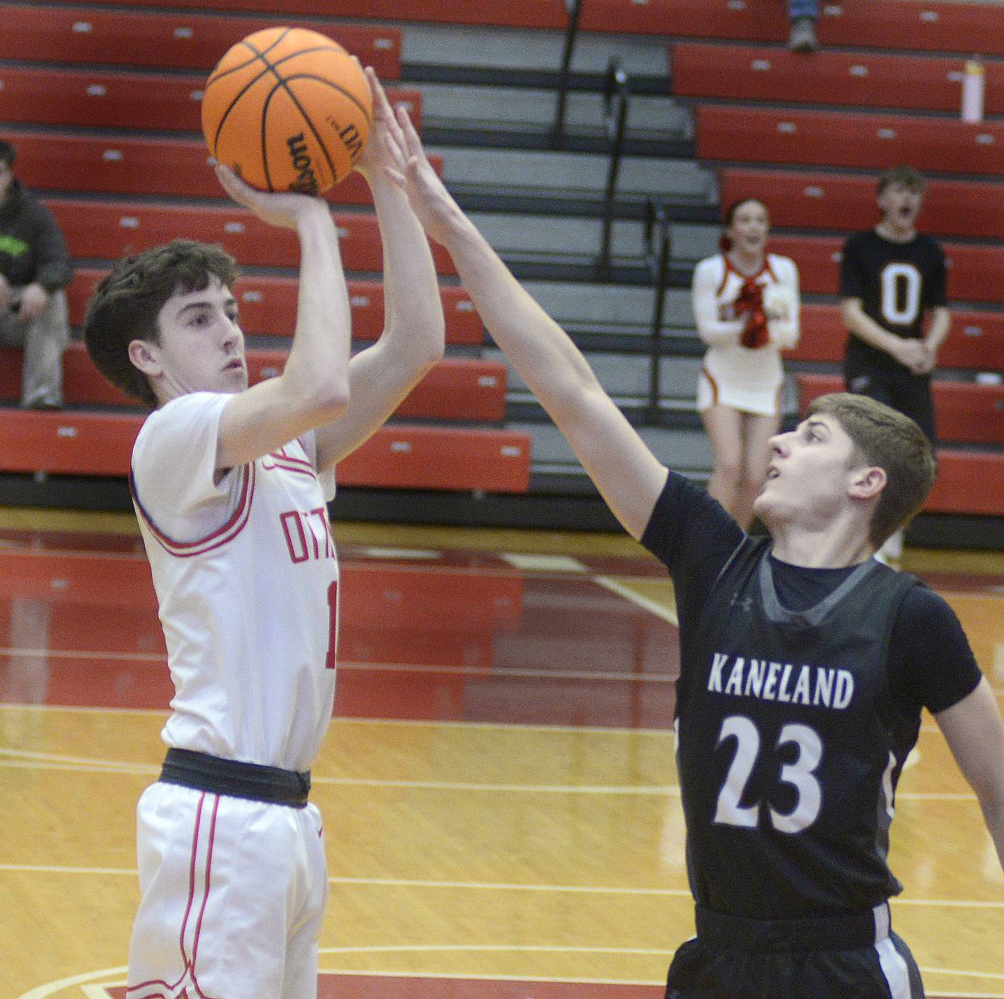 Kaneland’s Connor Kimme tries to block a 3 point shot from Ottawa’s Colt Bryson in the 1st quarter Tuesday at Ottawa.