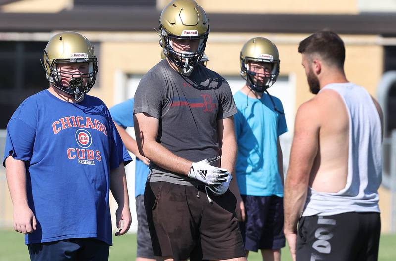 Hiawatha football head coach Nick Doolittle talks to his team Wednesday, Aug.10, 2022, during practice at the school in Kirkland.