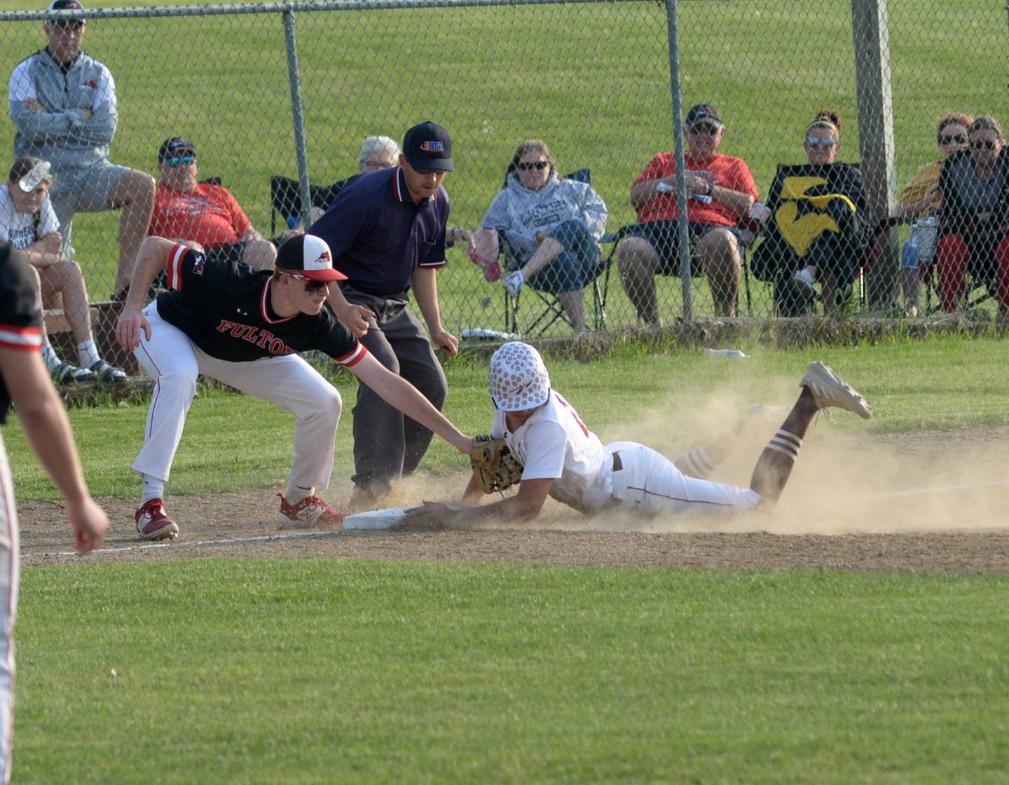 Fulton's Ethan Price tags a Dakota runner as he reaches third base safely during afternoon action at the 1A Pearl City Sectional on Wednesday, May 24.