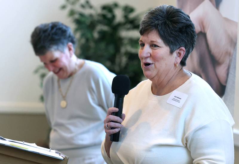 Kris Wrenn, (right) who owned and operated Kar-Fre Flowers along with her sister Michelle Schulz, speaks as her sister looks on after they were introduced as the winners of the Clifford Danielson Outstanding Citizen Award during the Sycamore Chamber of Commerce Annual Meeting Thursday, March 6, 2025, at St. Mary's Catholic Church in Sycamore.
