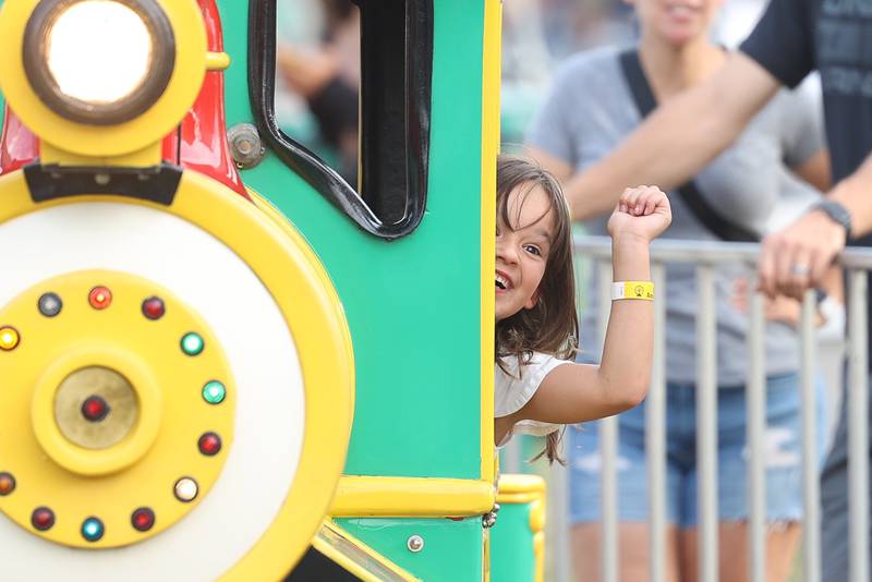 Evelyn Steg, 6-years old, waves to her parents while riding the train on day 2 of the Taste of Joliet. Saturday, June 25, 2022 in Joliet.