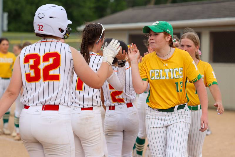 Aleigh Hill (13) of Providence leads team in line to high-five players of Tinley Park after win on Tuesday, June 3, 2025 at Ottawa High School in Ottawa.