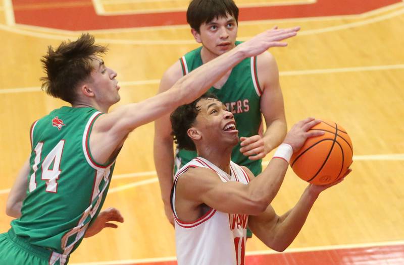 Ottawa's Hezekiah Joachim eyes the hoop as L-P's Wyatt Kilday and Erick Sotelo defend on Friday, Feb. 6, 2026 in Kingman Gymnasium at Ottawa High School.