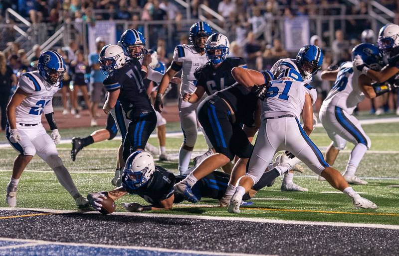 St. Charles North's Drew Surges (6) dives into the end zone for a touchdown against Lake Zurich during a football game at St. Charles North High School on Friday, Sep 2, 2022.
