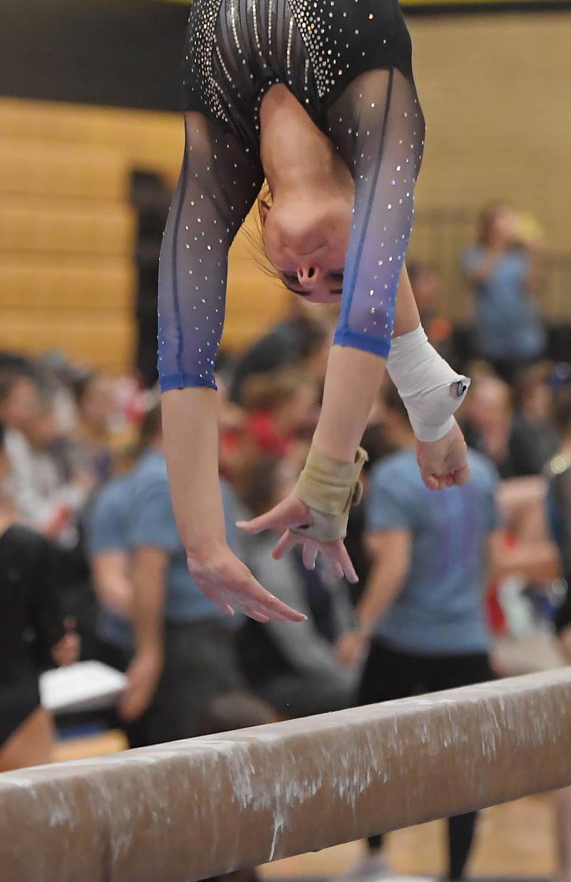 Geneva's Graci Weems on the balance beam at the Hinsdale South girls gymnastics sectional meet in Darien on Tuesday, February 7, 2023.