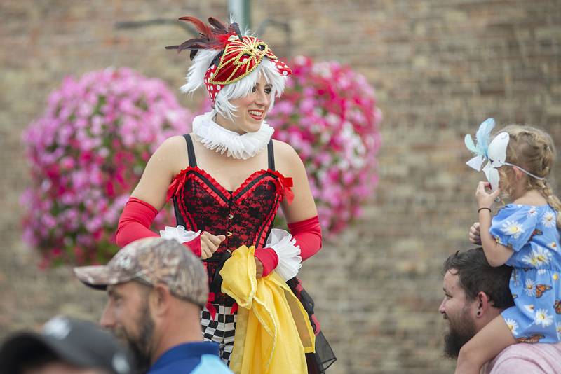 Stilt performer Ellen DeSitter sees eye to eye with Lillienne Geerts, 4, with the help of dad Cameron Saturday, August 14, 2022 during Dixon Main Street’s Venetian Night.