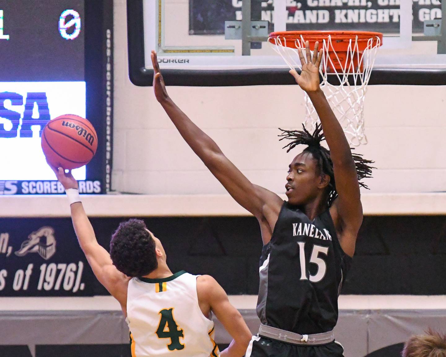Crystal Lake South's Anthony Demirov (4) makes a basket over Kaneland's Freddy Hassan (15) during the sectional championship game on Friday March 1, 2024, held at Kaneland High School.