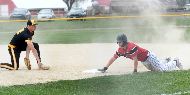 Forreston's Kye Alderks dives safely back to first base during a Monday, April 28, 2025 game with Lena-Winslow at Forreston High School.