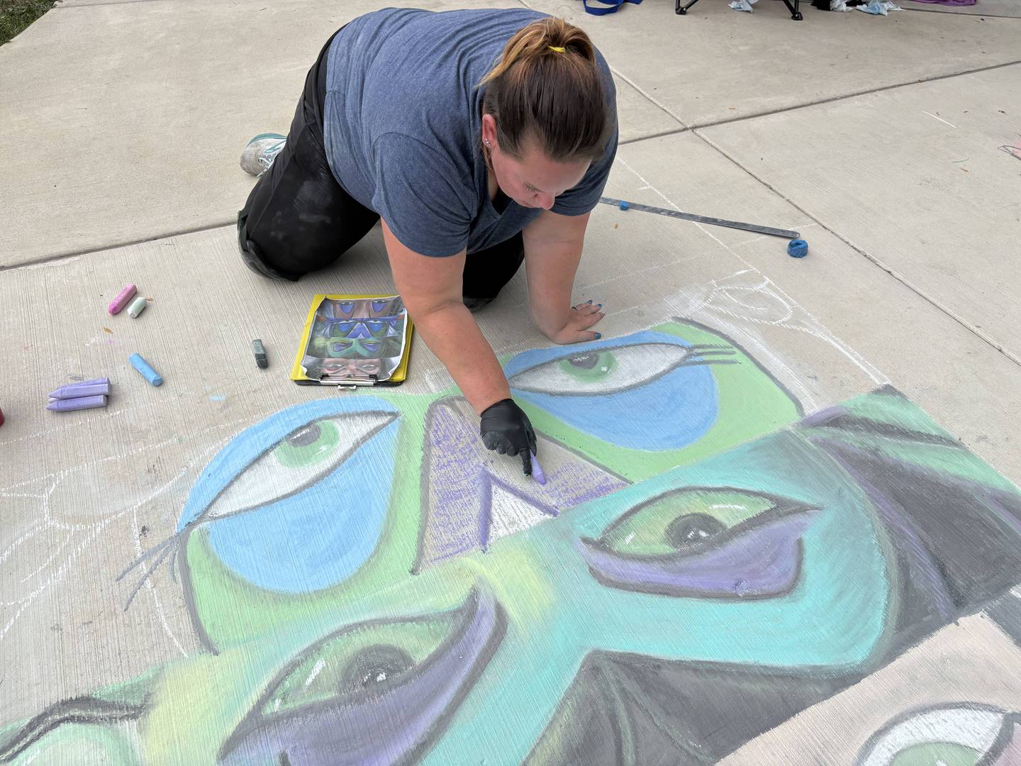 Rachel Salee draws her chalk work at the McHenry Riverwalk chalkwalk Sept. 21, 2025.