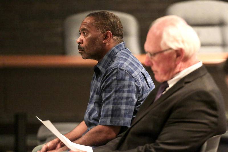 Lionel Allen listens to his attorney Jeff Burke speak to the Joliet Police and Fire Board on July 8, 2019, in Joliet.